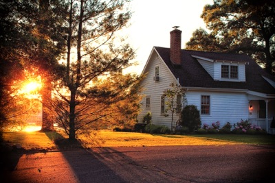 House with sunset behind it