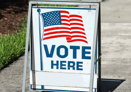 SIGN READING VOTE HERE OUTSIDE